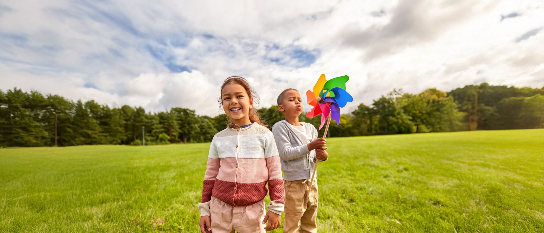 Two smiling children playing outdoors in Westchester County